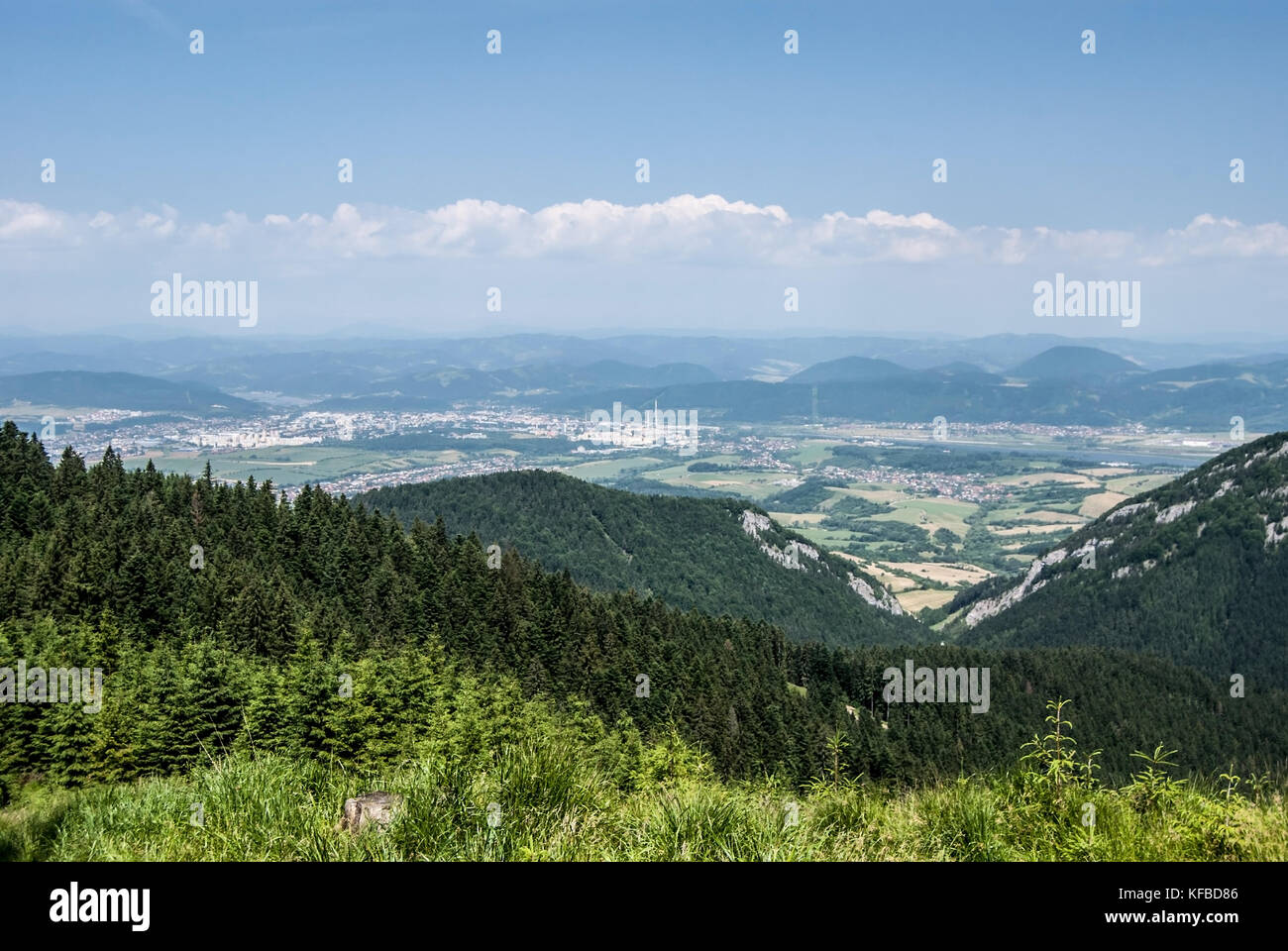 Zilina city with Vah river valley and hills around in Slovakia from meadow near hiking trail between Mincol hill and Visnove in Mala Fatra mountains Stock Photo