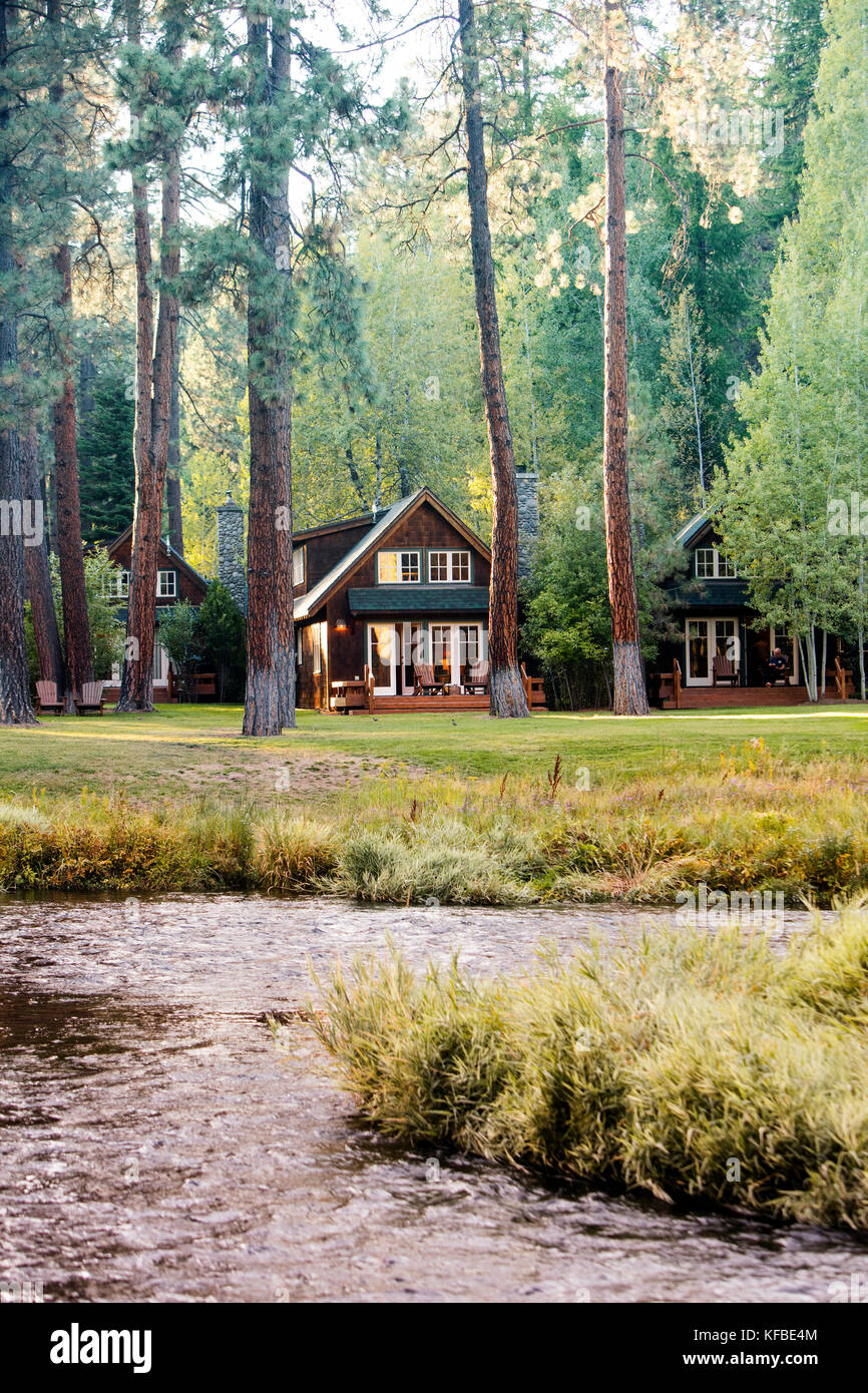 USA, Oregon, Camp Sherman, Metolius River Resort, View of cabins from River Stock Photo