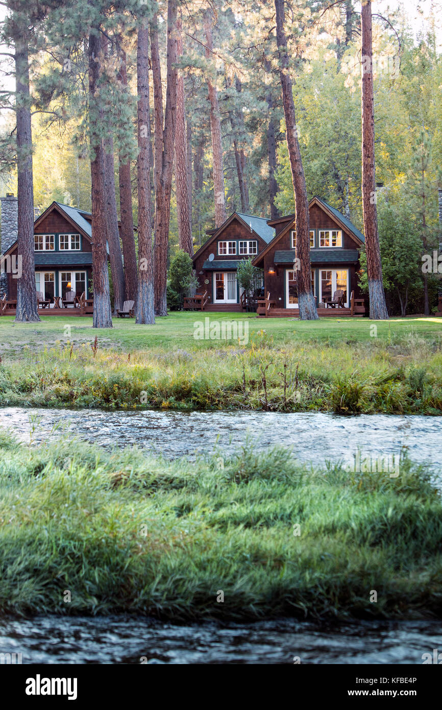 USA, Oregon, Camp Sherman, Metolius River Resort, View of cabins from River Stock Photo