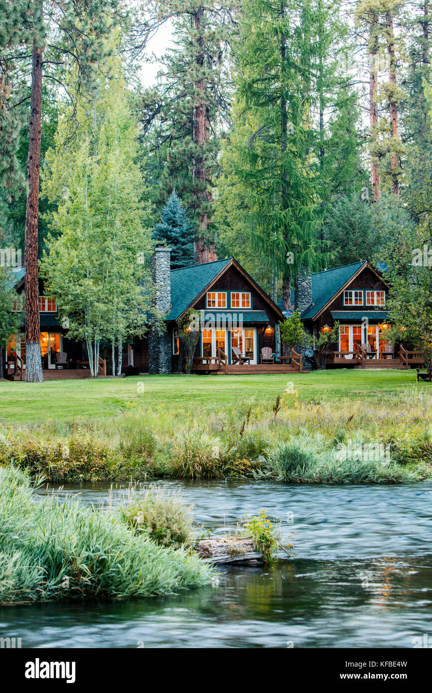 USA, Oregon, Camp Sherman, Metolius River Resort, View of cabins from River Stock Photo