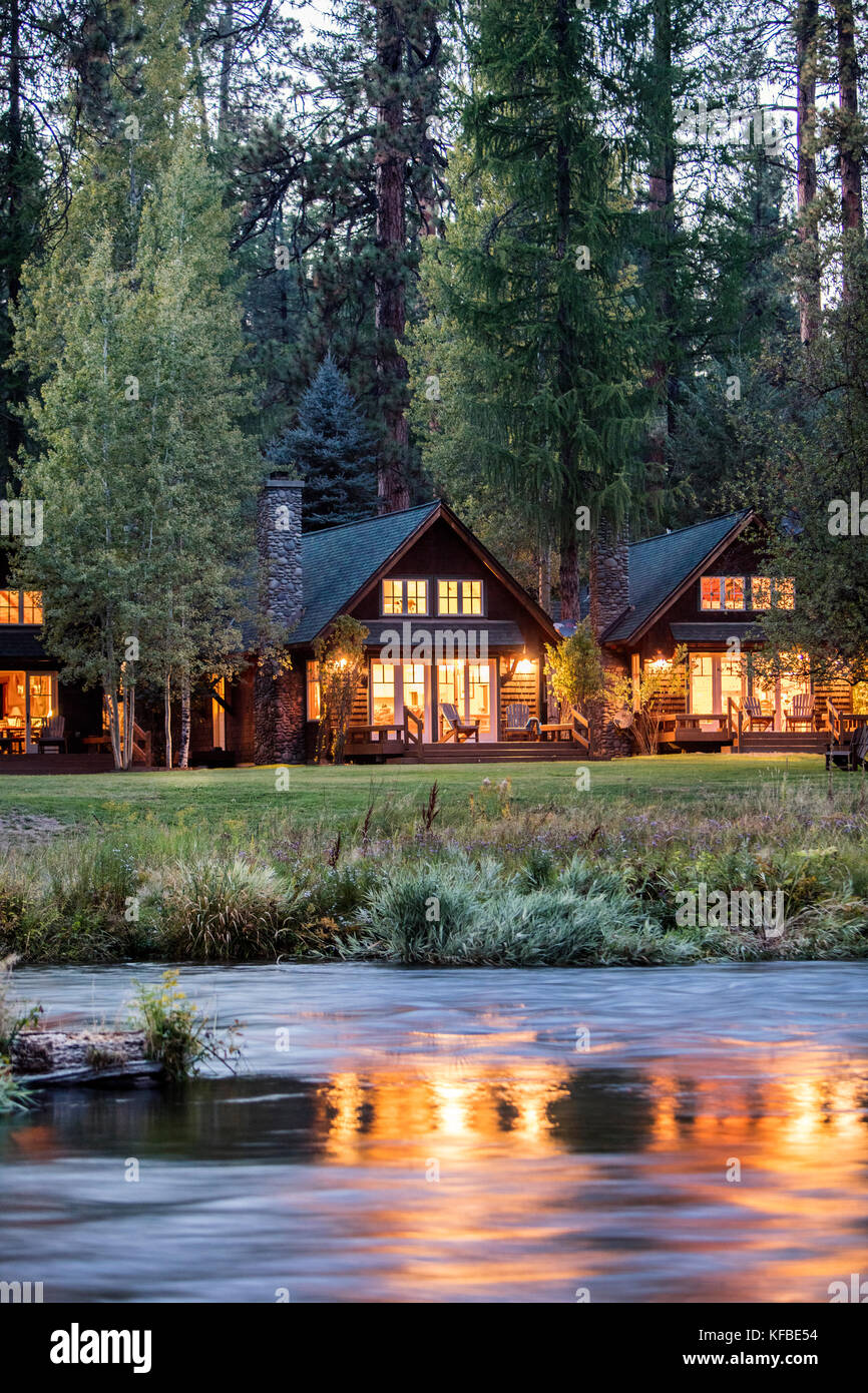 USA, Oregon, Camp Sherman, Metolius River Resort, View of cabins from River Stock Photo