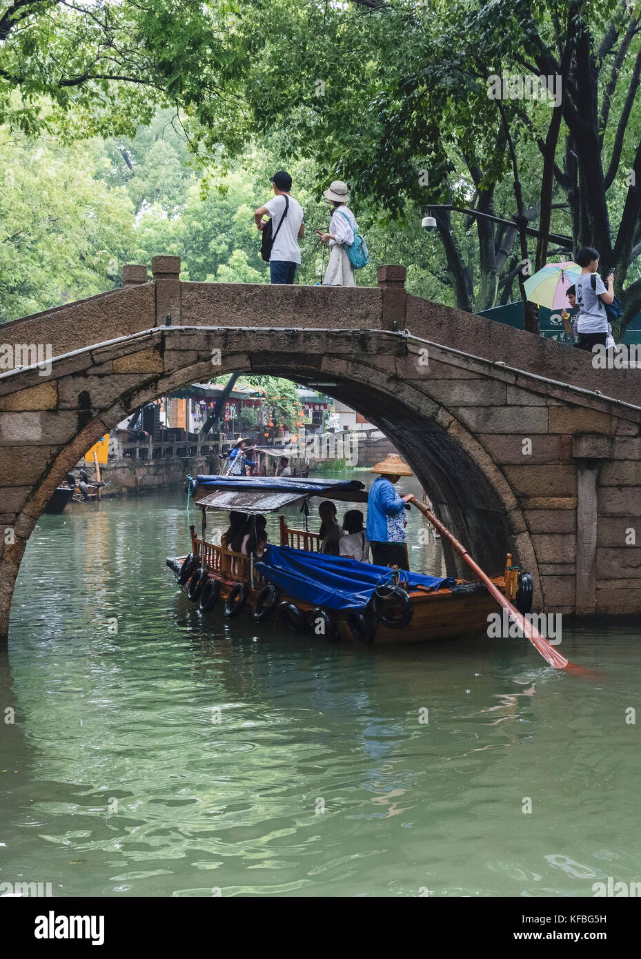 Chinese Rowing Boat Stock Photo - Tourists ride in row boats in a canal in an ancient town ...