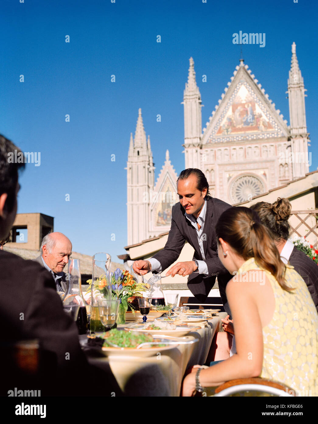 ITALY, Orvieto, Umbria, Chef Alex Palermo serving lunch on the rooftop