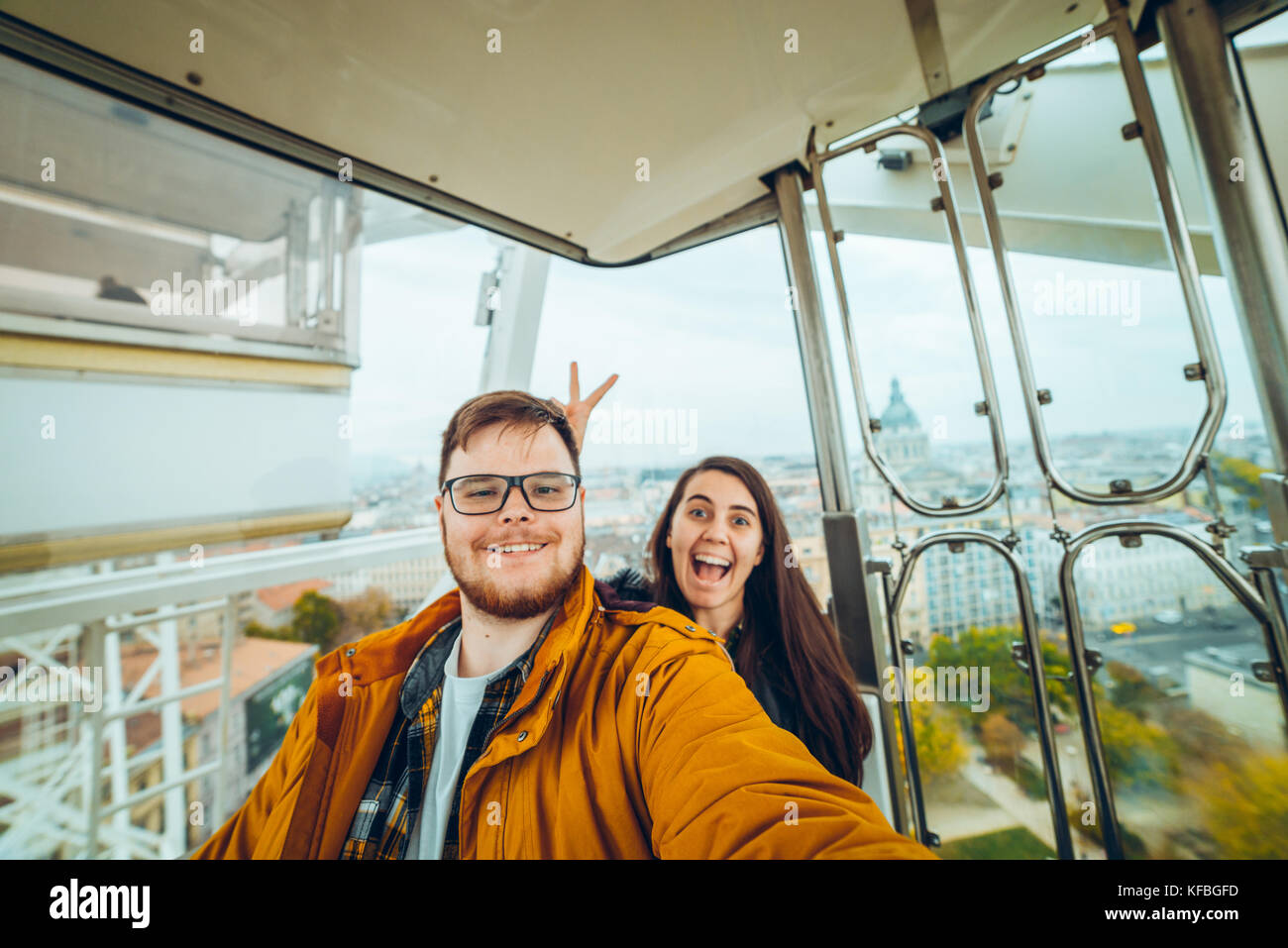 man with woman at ferris wheel taking a selfie Stock Photo