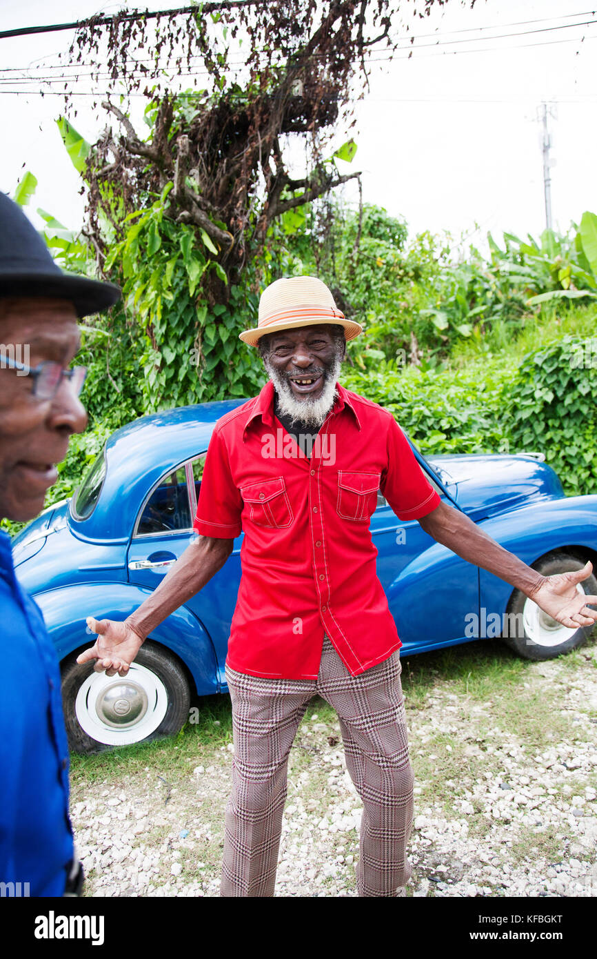 JAMAICA, Port Antonio. Joseph "Powder" Bennett and Derrick "Johnny" Henry of the Mento band, The Jolly Boys standing in front of a vintage blue car. Stock Photo