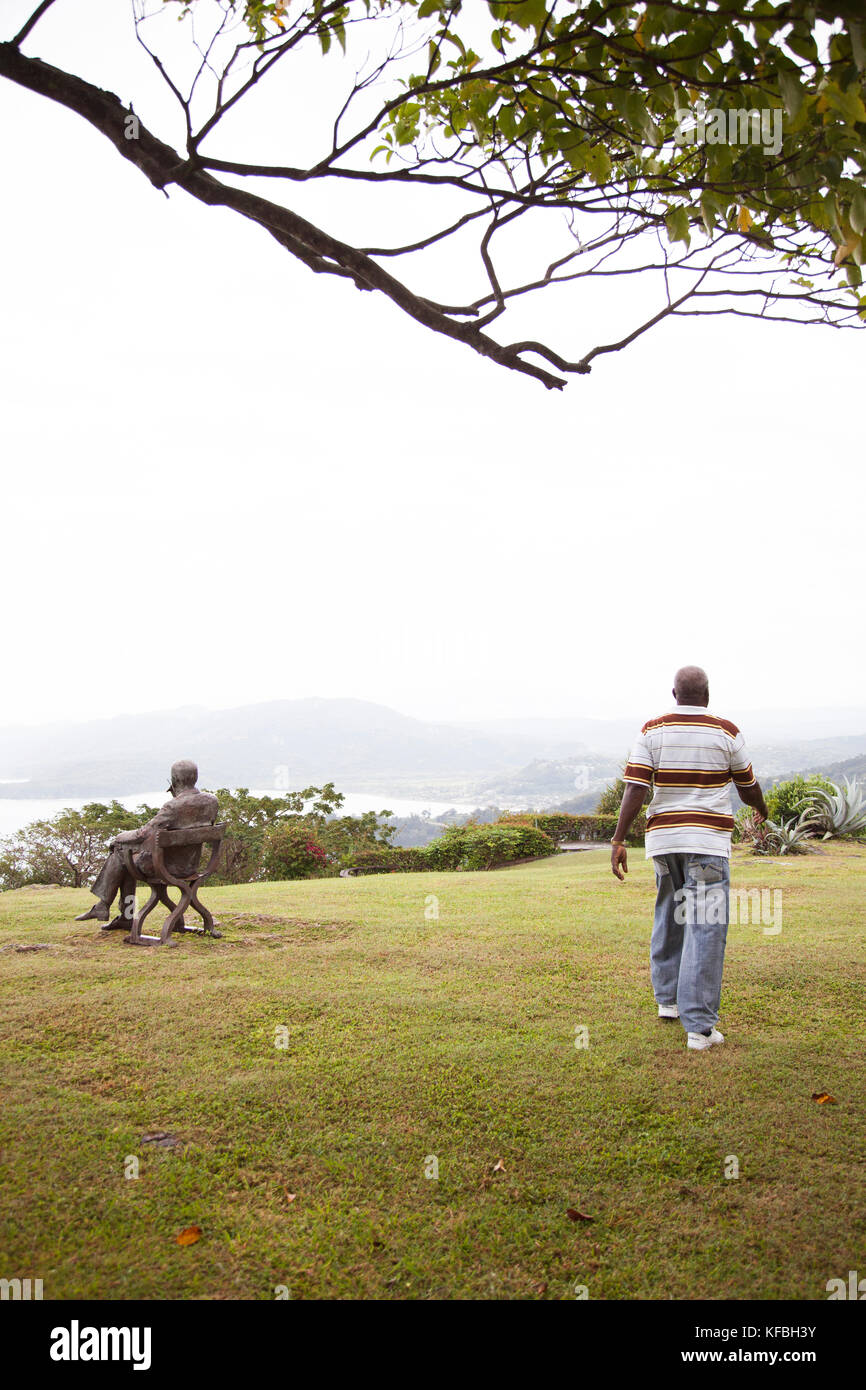 JAMAICA, Ocho Rios. Caretaker and a sculpture of Noel Coward seating at Firefly, the house of playwright Noel Coward. Stock Photo