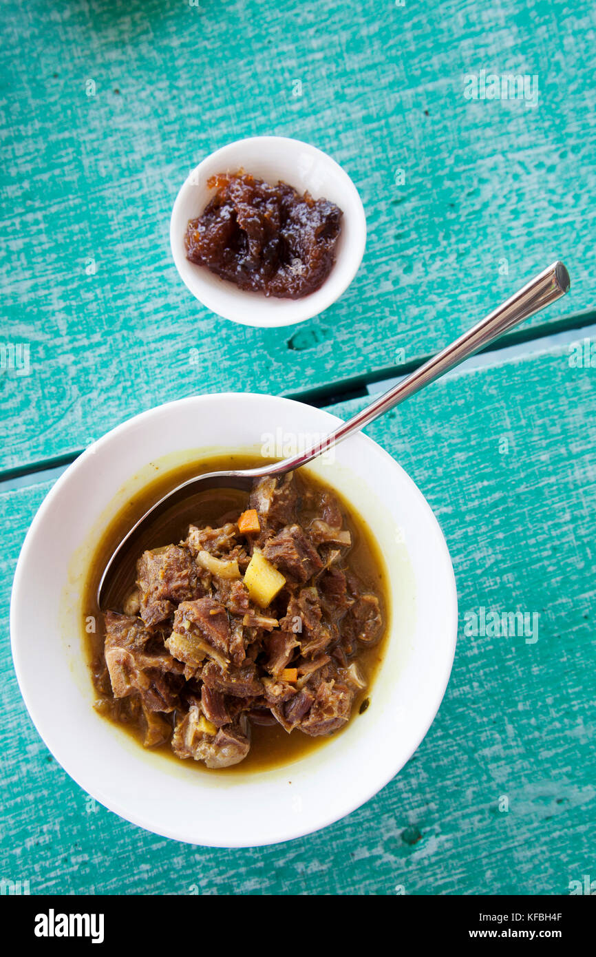 JAMAICA, Oracabessa. Goldeneye Hotel and Resort. Goat curry at the restaurant and bar during