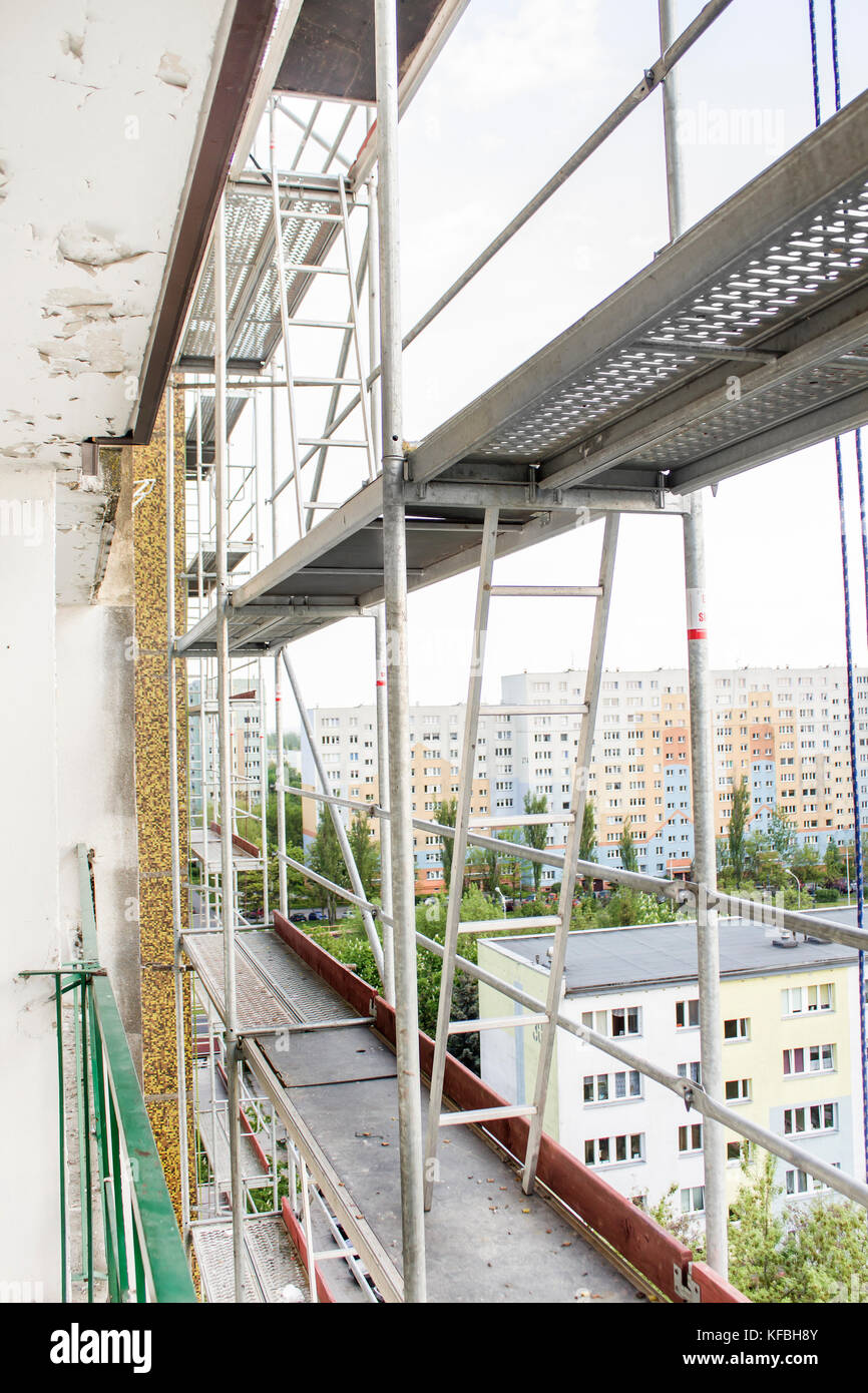 Scaffolding set on a skyscraper. A building built of large concrete