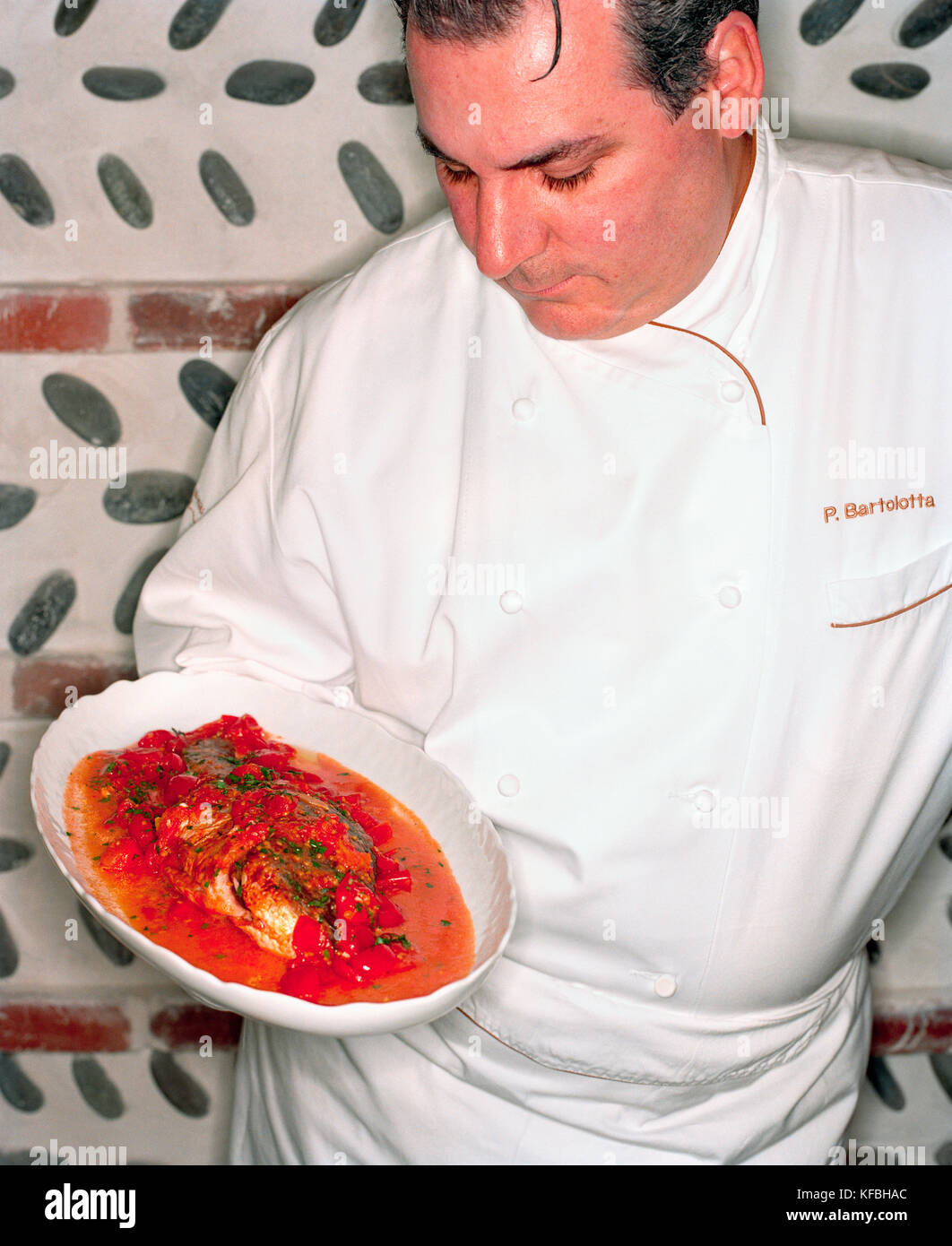 USA, Nevada, Chef Paul Bartolotta holding dish at his Restaurant Bartolotta at the Wynn Hotel. Stock Photo
