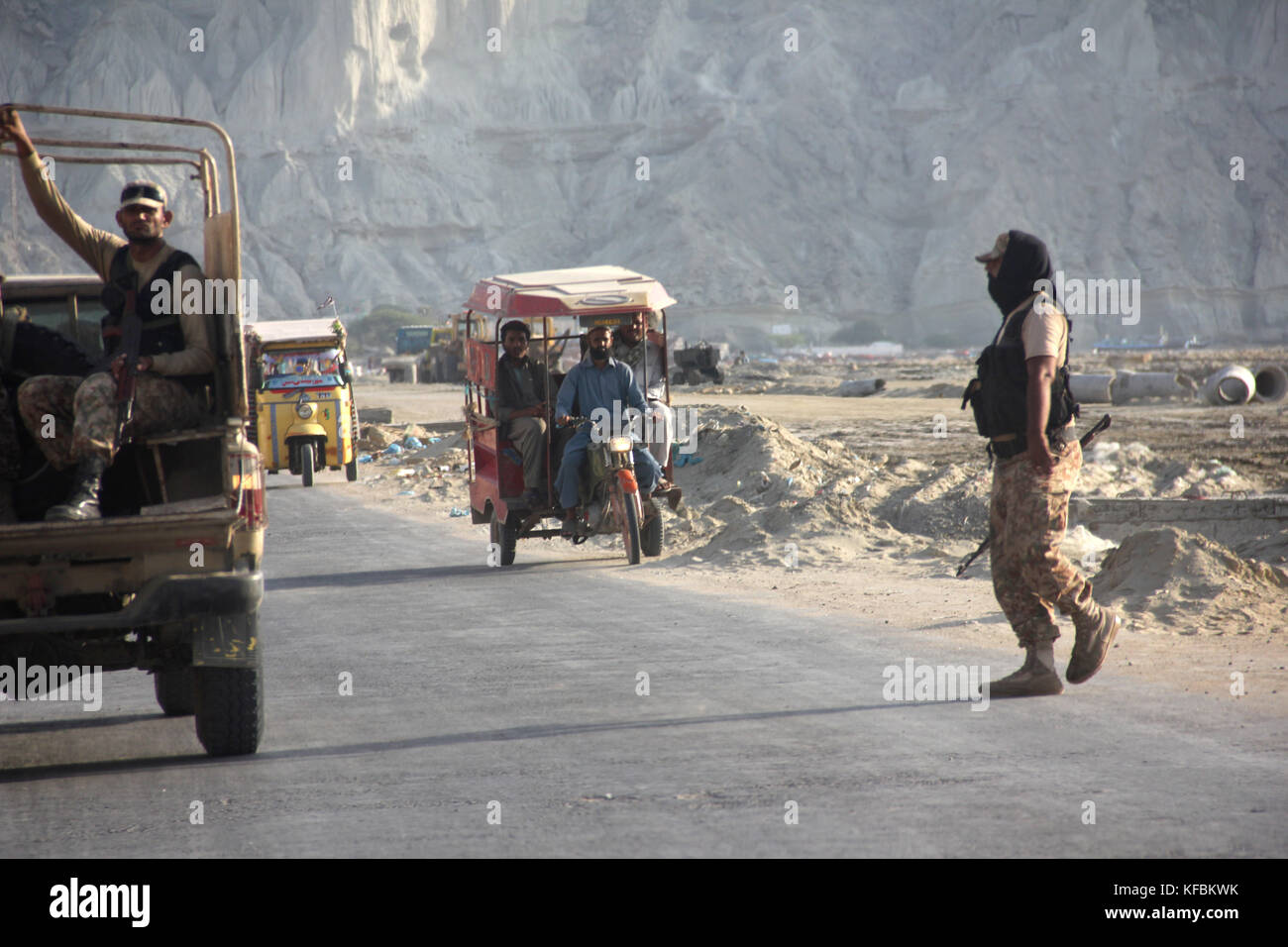 Pakistani soldiers stopping traffic in order to control acccess to a heavily protected visitors' colony in the port town of Gwadar in southern Pakistan, 04 October 2017. Gwadar is located in Baluchistan, the least safe province of Pakistan, and is the core of a multi-billion economic corridor planned with China (CPEC). Much is being bet on the CPEC. Photo: Christine-Felice Röhrs/dpa Stock Photo