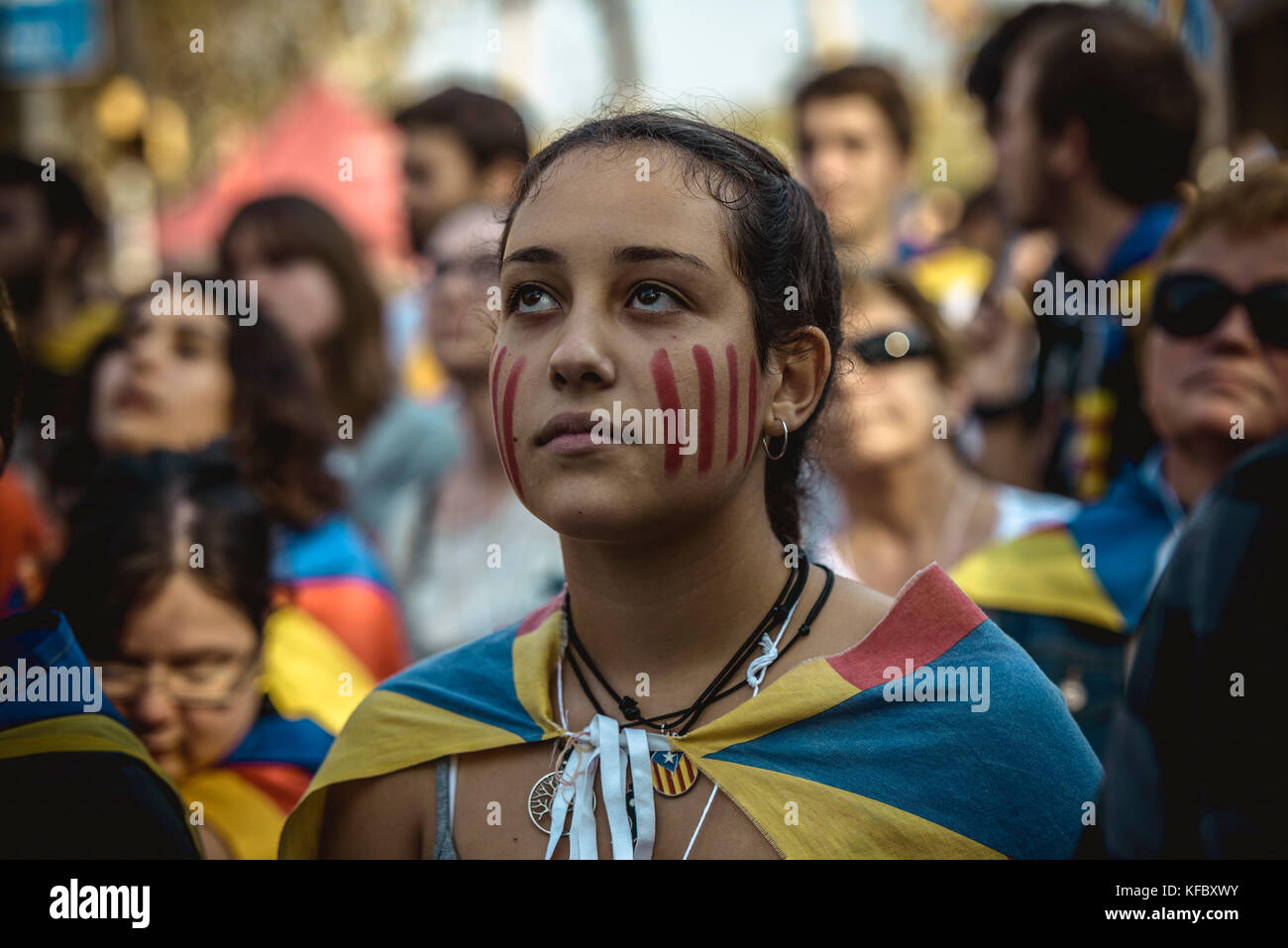 Barcelona, Spain. 27 October, 2017:  A Catalan separatist follows outside the Catalan Parliament the independence vote on a big screen Credit: Matthias Oesterle/Alamy Live News Stock Photo
