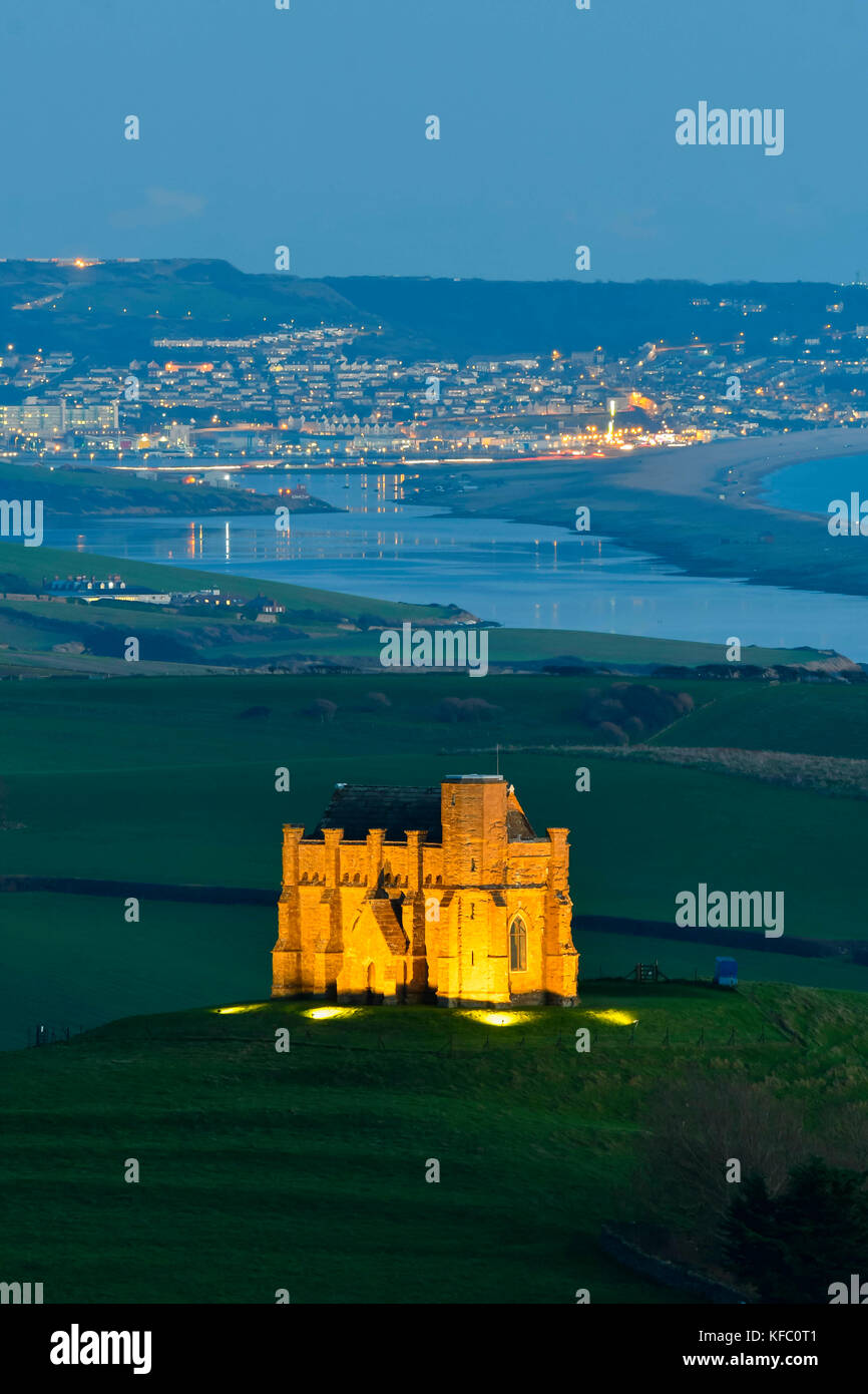 Abbotsbury, Dorset, UK.  27th October 2017.  UK Weather.  St Catherine's Chapel at Abbotsbury in Dorset is illuminated at dusk for the annual  Enchanted Illuminations event at Abbotsbury Subtropical Gardens on an evening of clear skies and light winds with a view along the Fleet towards the Isle of Portland.  The final day of the illuminations at the gardens is on Sunday 29th October. Photo Credit: Graham Hunt/Alamy Live News Stock Photo