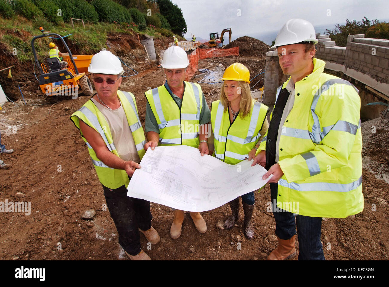 Interior and building designer Claire Alderson (red top, overseeing work on a property in Cornwall Stock Photo