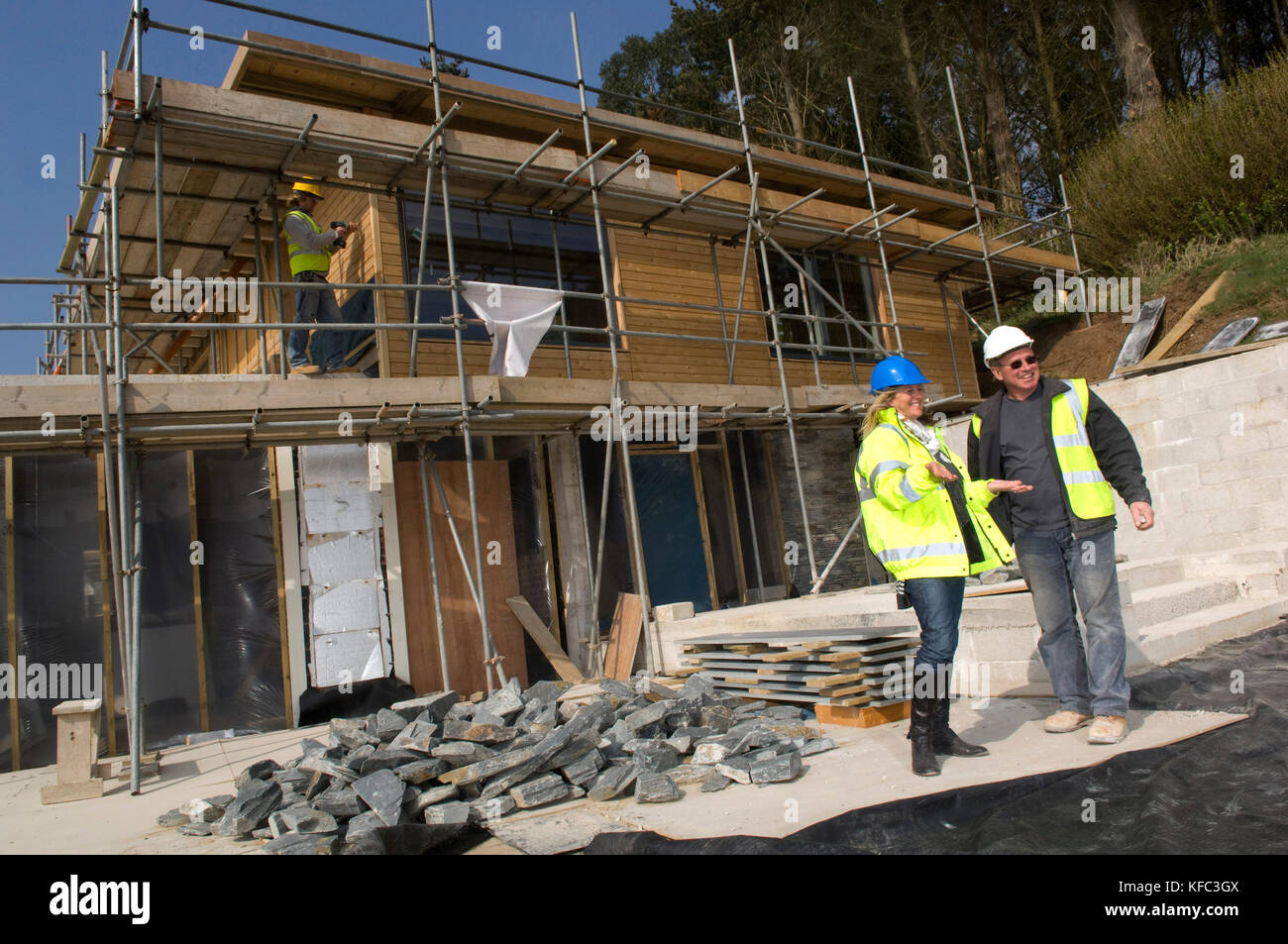 Interior and building designer Claire Alderson (red top, overseeing work on a property in Cornwall Stock Photo
