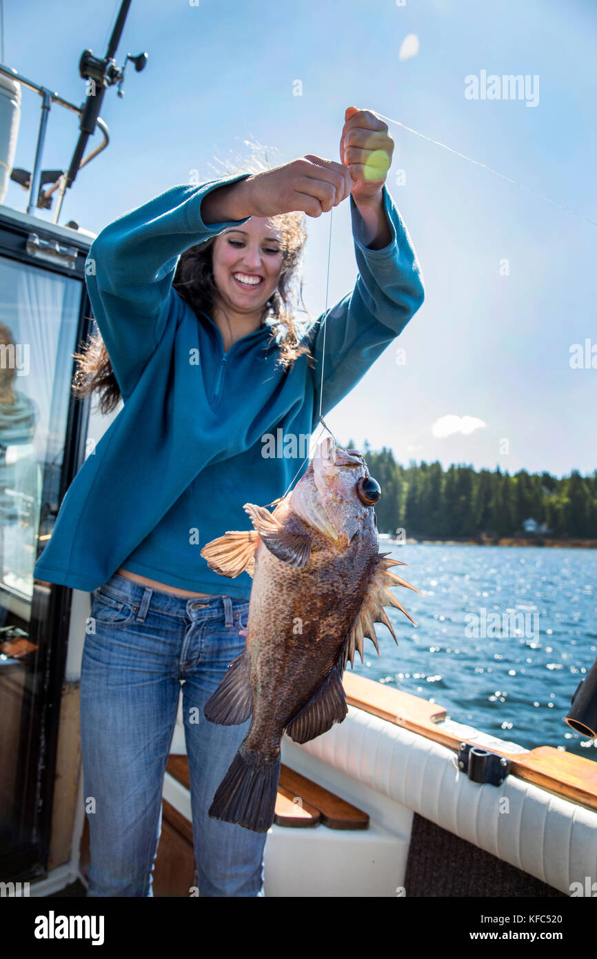 USA, Alaska, Ketchikan, a female fisherman shows off her catch while  fishing the Behm Canal near Clarence Straight, Knudsen Cove along the  Tongass Nar Stock Photo - Alamy