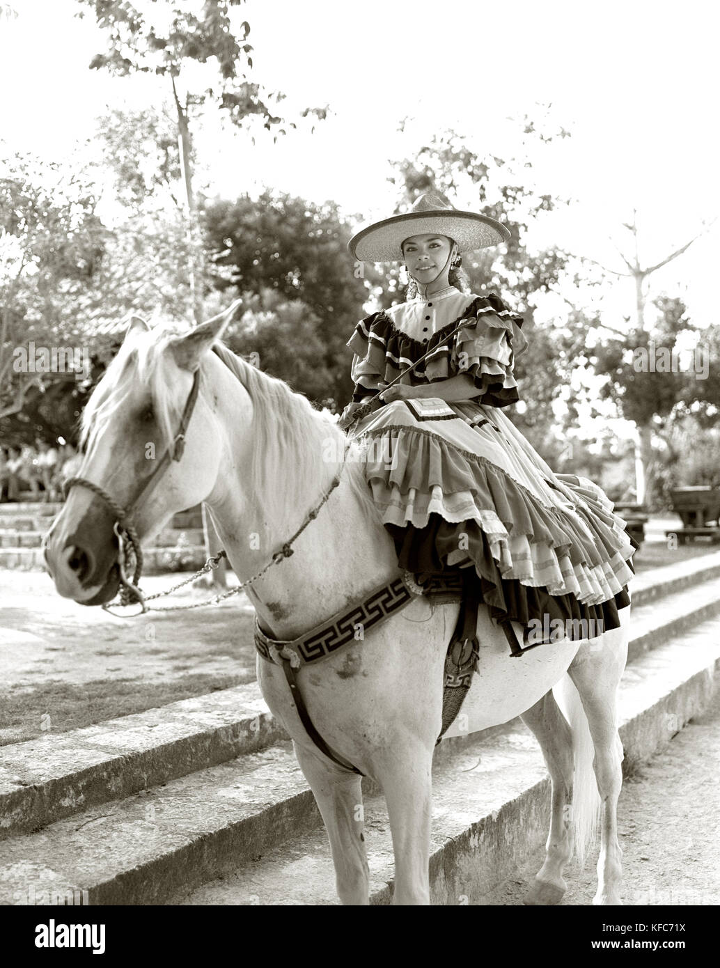 MEXICO, Maya Riviera, Mexican Cowgirl wearing sombrero sitting on horse (B&W) Stock Photo