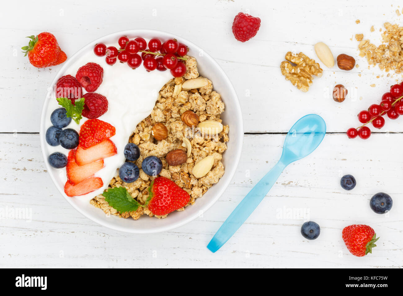 Muesli breakfast fruits yogurt strawberries cereals berries bowl top view from above Stock Photo