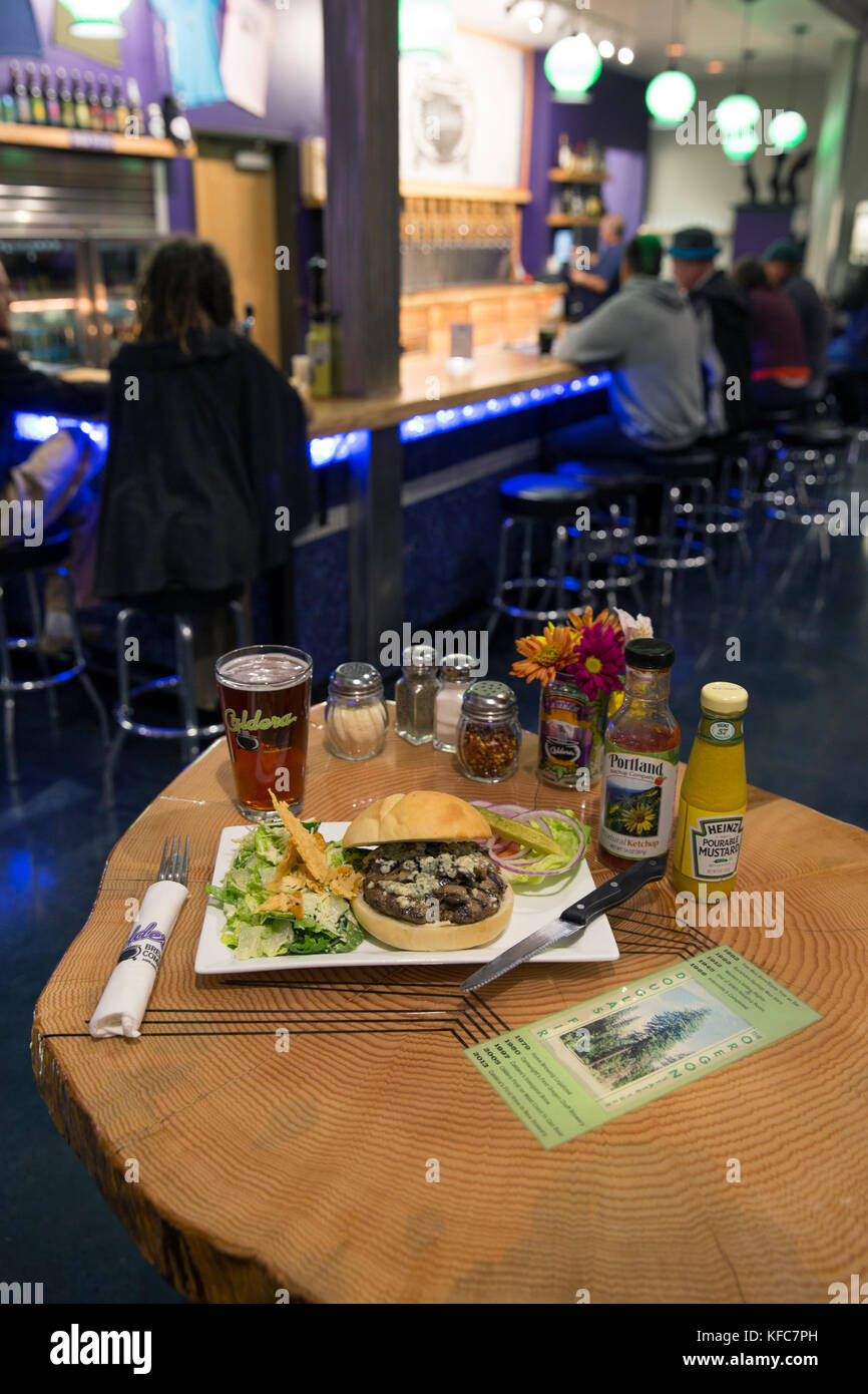 USA, Oregon, Ashland, truffle burger at the Caldera Brewery and Restaurant, the table is made from the same tree as the bar Stock Photo