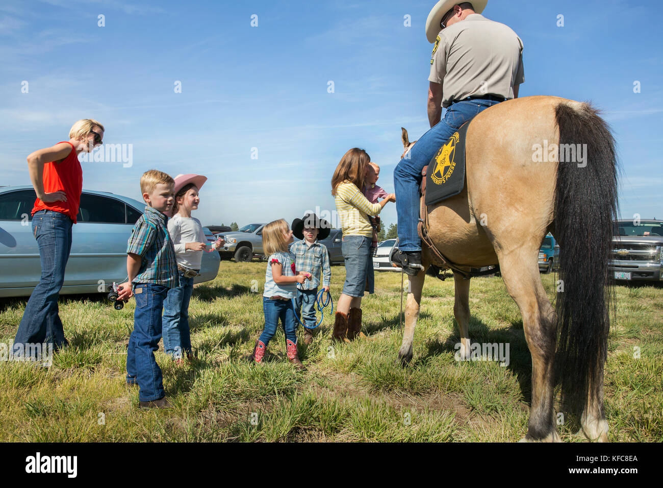 USA, Oregon, Sisters, Sisters Rodeo, young kids meet and pet the