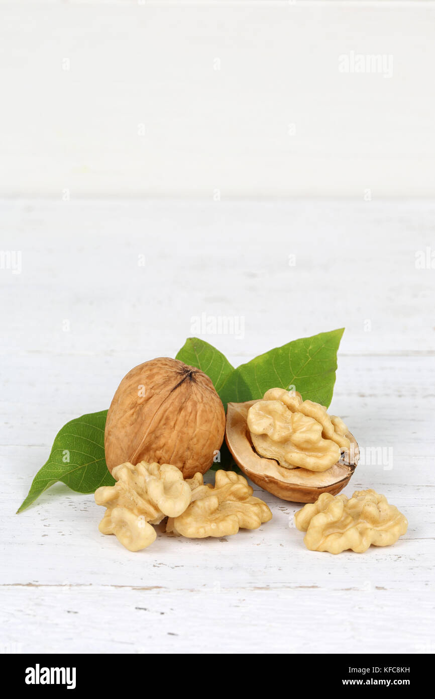 Walnuts walnut nuts nut nutshell portrait format copyspace on wooden board food Stock Photo