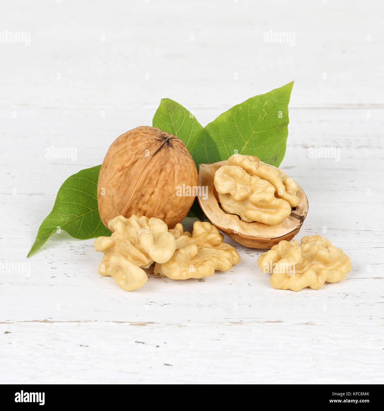 Walnuts walnut nuts nut nutshell square on wooden board food Stock Photo