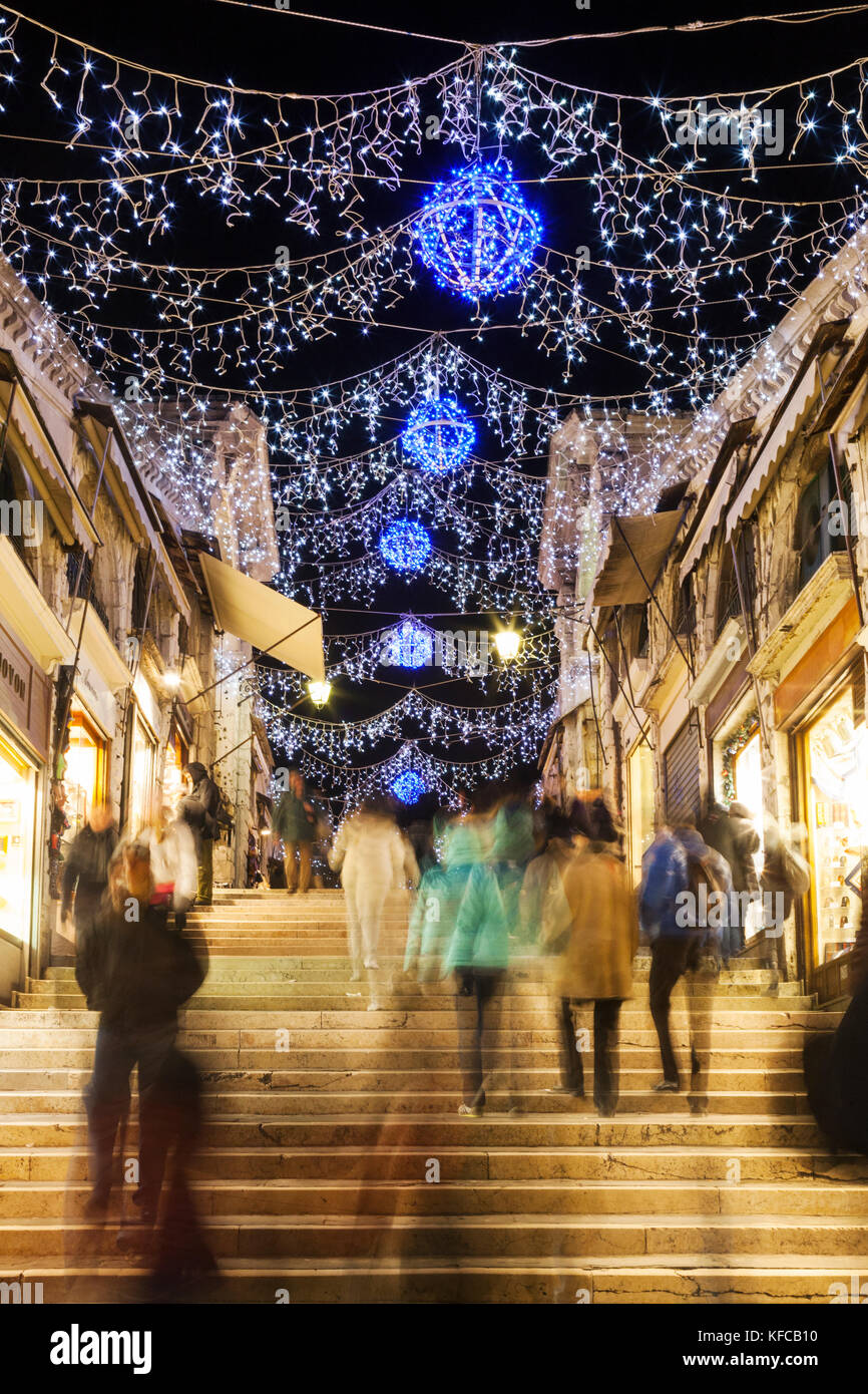 ITALY, Venice. Christmas decorations hangs over the steps leading up