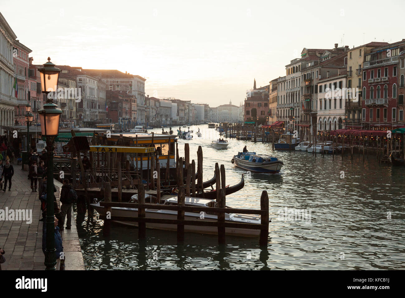 ITALY, Venice. View of the Grand Canal, Homes, Shops and Restaurants at sunset from the Rialto Bridge. Stock Photo