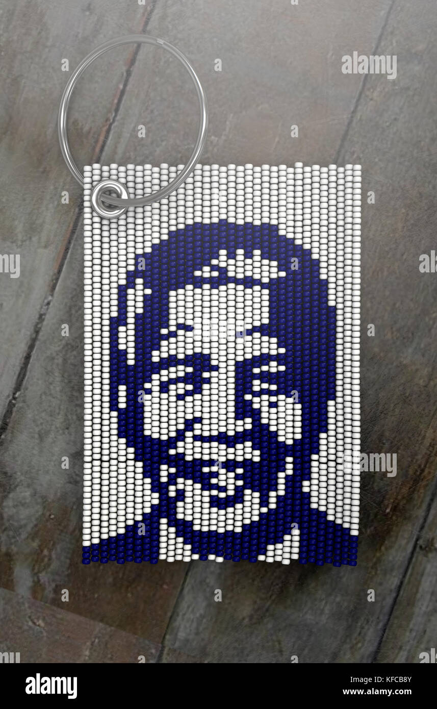 A traditional zulu beaded keyring depicting nelson mandela on an isolated wood background - 3D render Stock Photo