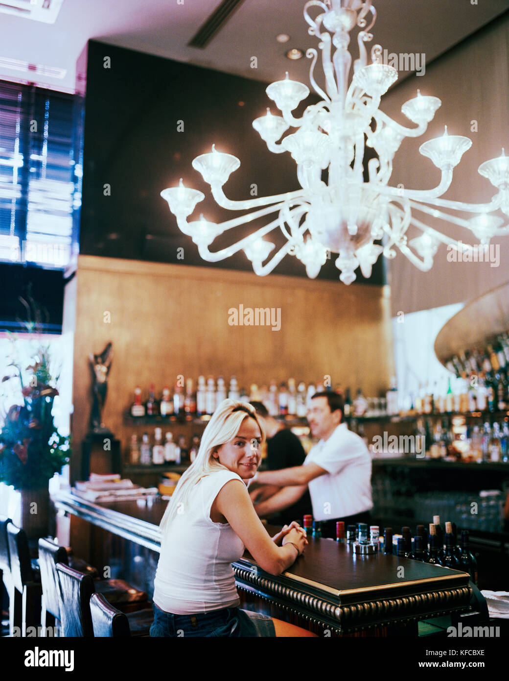 Woman sitting at a bar inside hi-res stock photography and images - Alamy