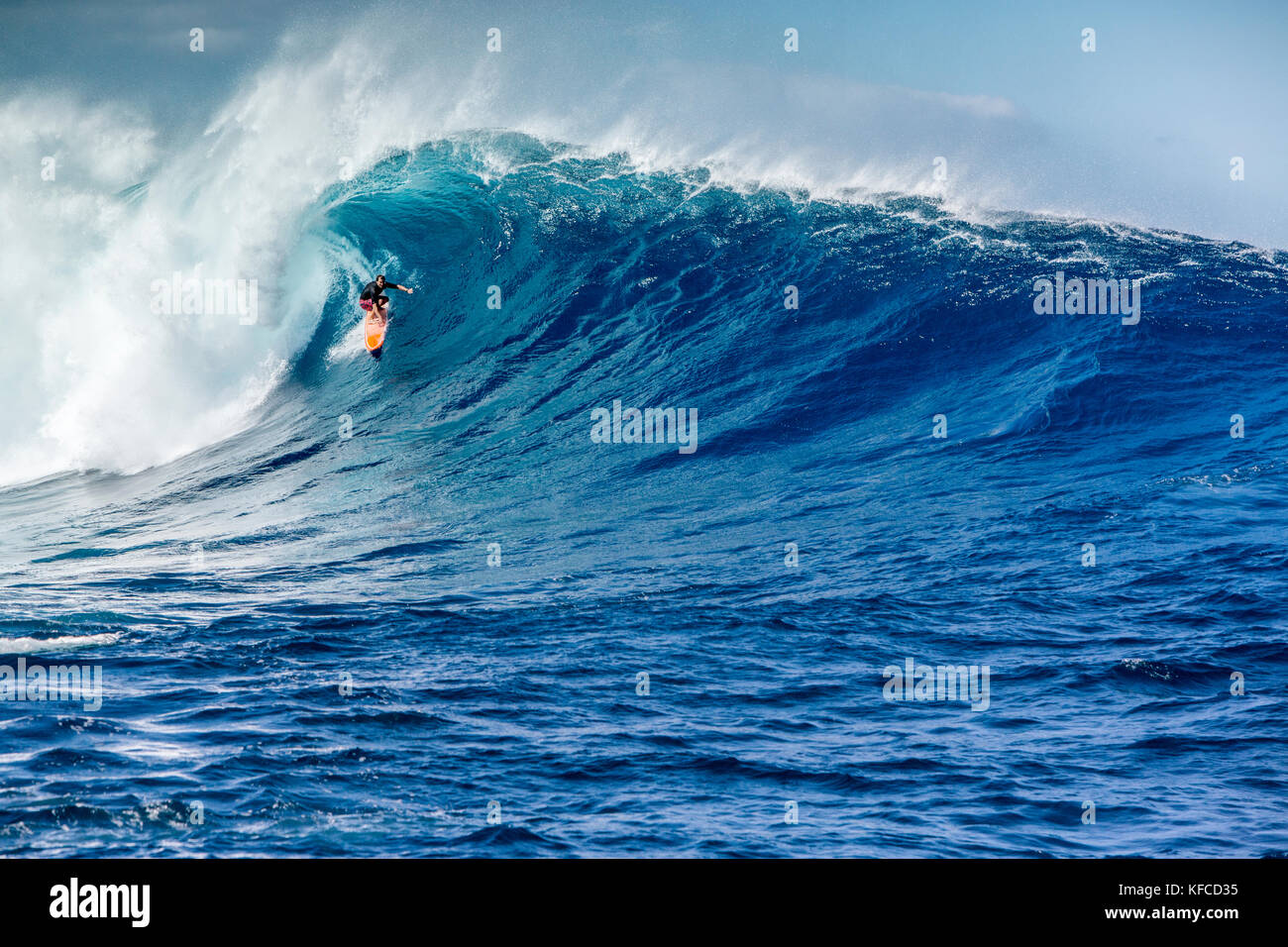 USA, HAWAII, Maui, Jaws, big wave surfers taking off on a wave at Peahi