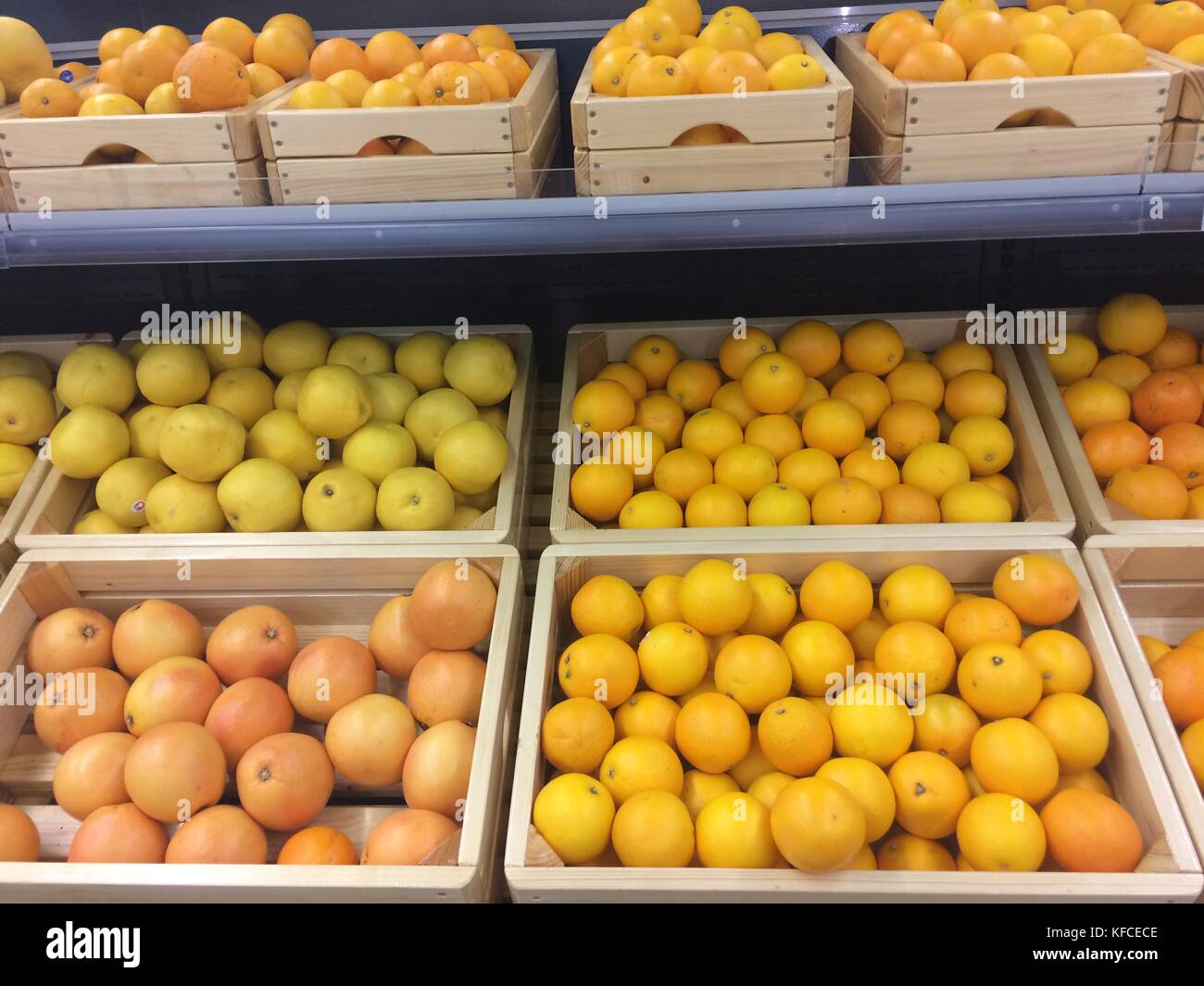 Fresh juicy oranges and grapefruits on store shelves Photo Stock Photo ...