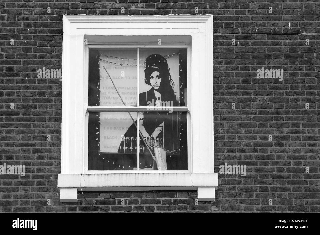 A poster of Amy Winehouse displayed on the window at The Hawley Arms pub in Camden Town, London. Stock Photo