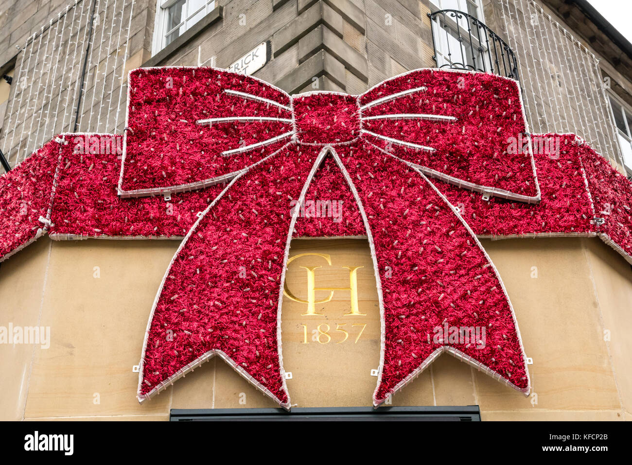 Giant christmas bow on shop front of chisholm hunter jewellers corner