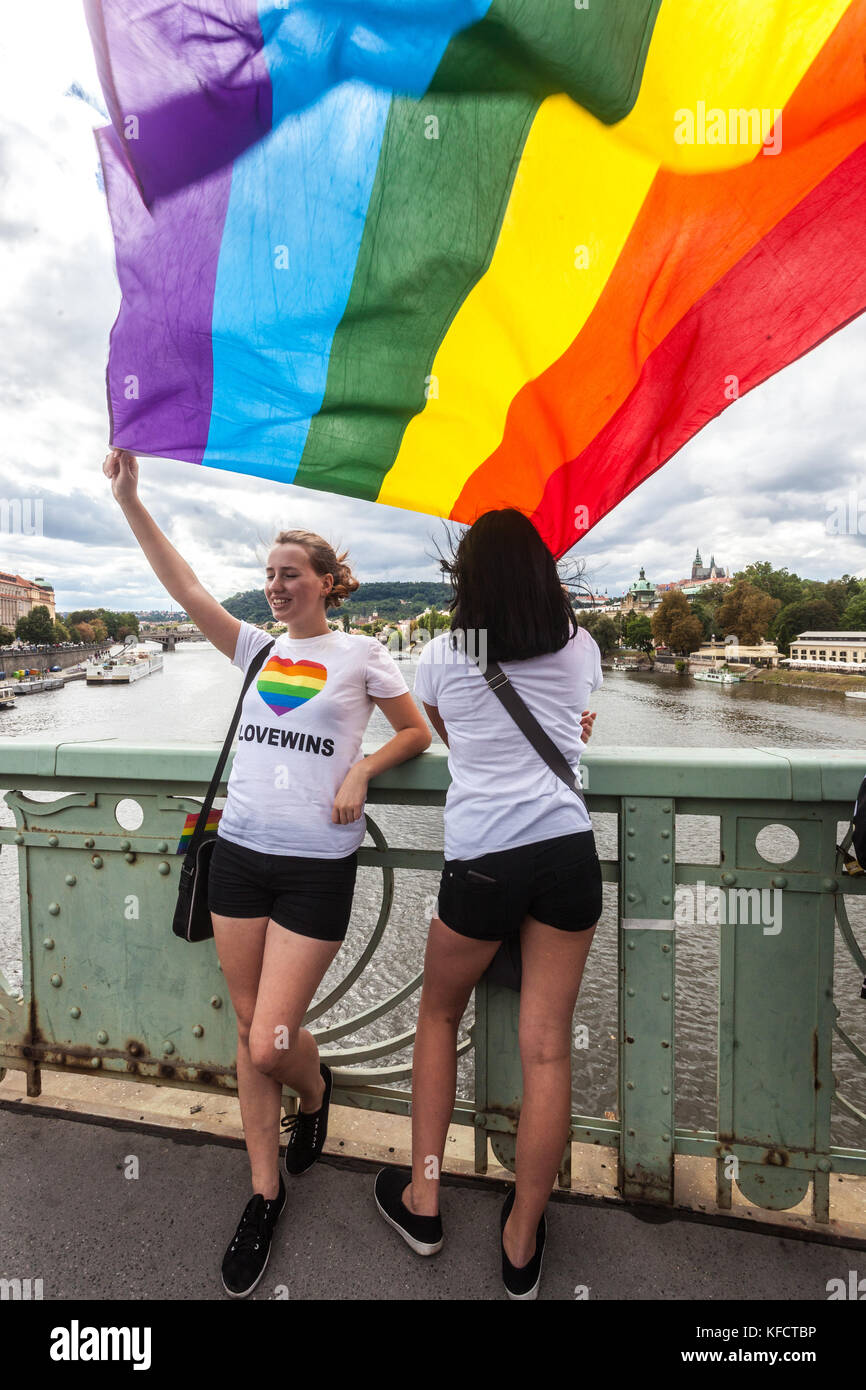 Two young girls, LGBT flag in the wind, Prague Pride, Czech Republic Stock Photo