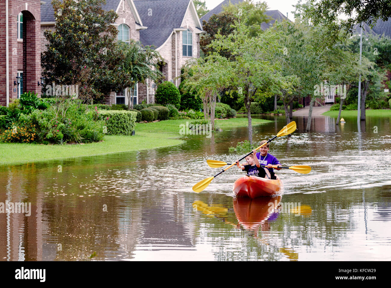 Residents of Sienna Plantation taking canoe rides in flooded street
