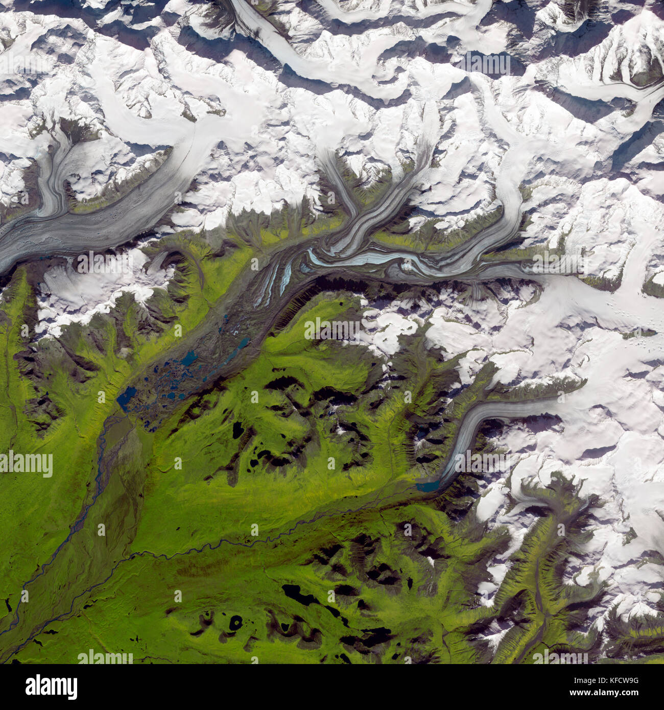 Aerial of Susitna Glacier, Alaska, August 27, 2009.  The glacier's surface is marbled with dirt-free blue ice and dirt-coated brown ice. Stock Photo