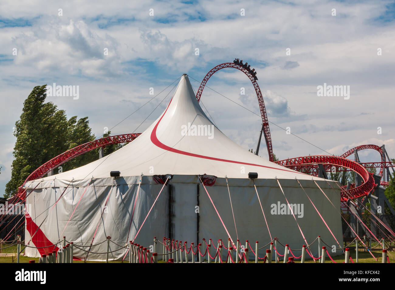 Circus Tent and Red Roller-coaster inside Public Amusement Park. Stock Photo