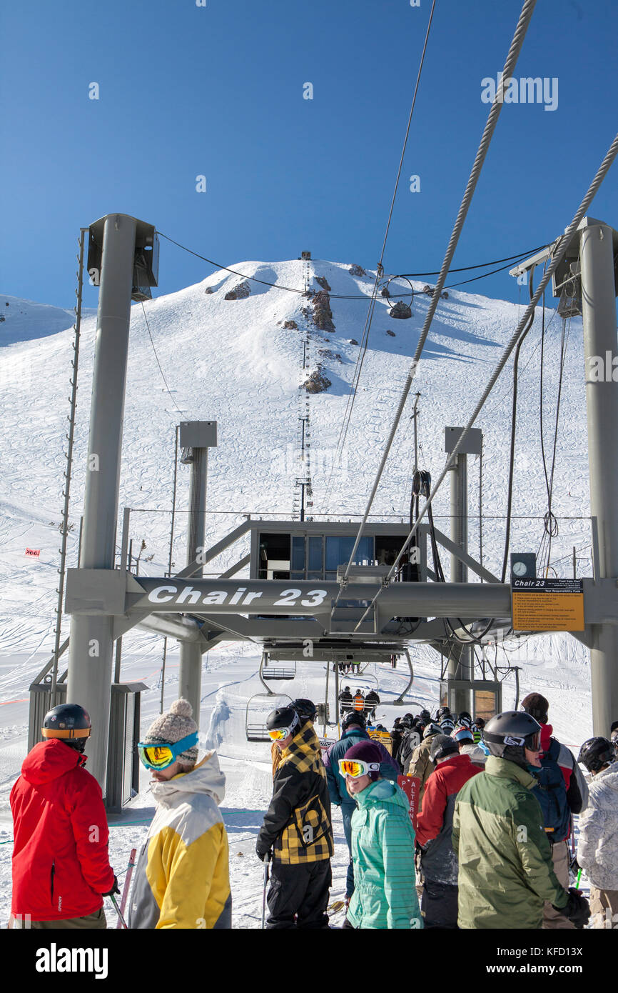 USA, California, Mammoth, skiers and snowboarders wait in line to ride ...