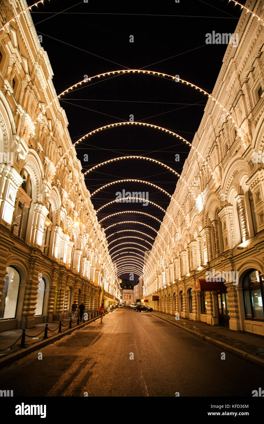 RUSSIA, Moscow. A street decorated with lights at night outside of GUM Department Store by the Red Square. Stock Photo