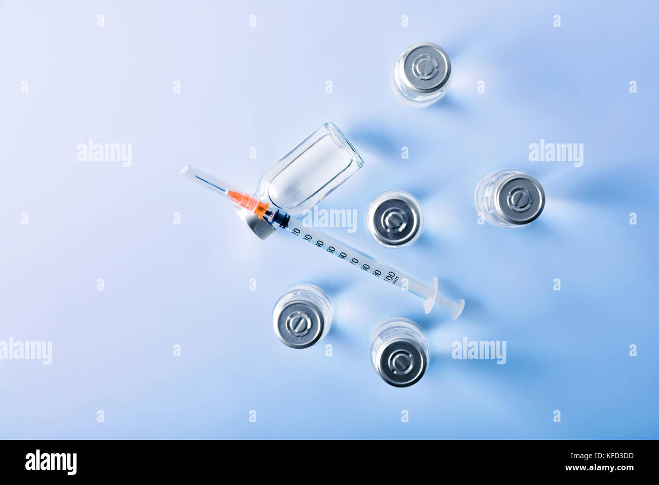 Group of vials with medication and syringe on blue methacrylate table ...