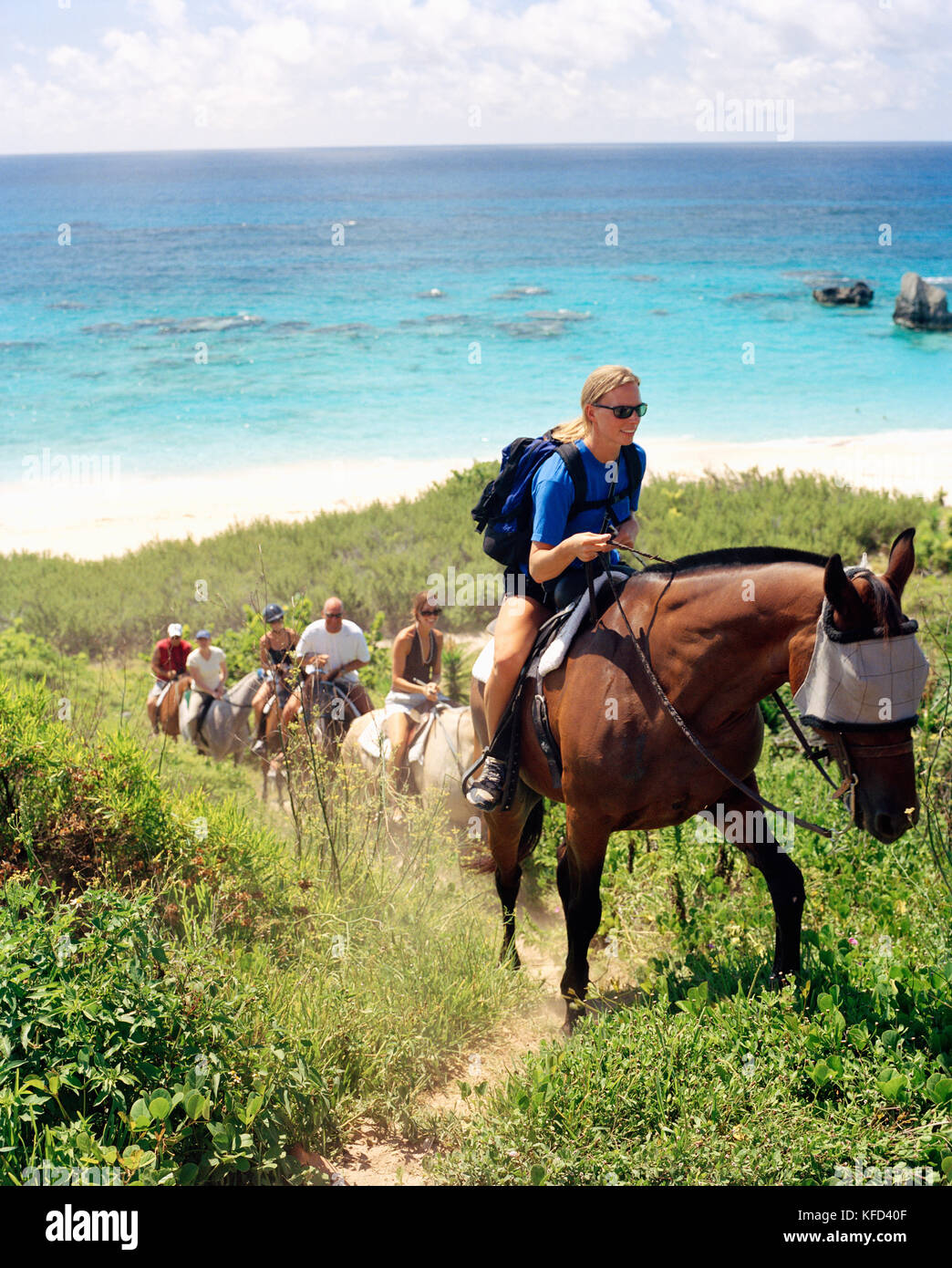 BERMUDA, Horseshoe Bay, tourists enjoying horseback riding with sea in