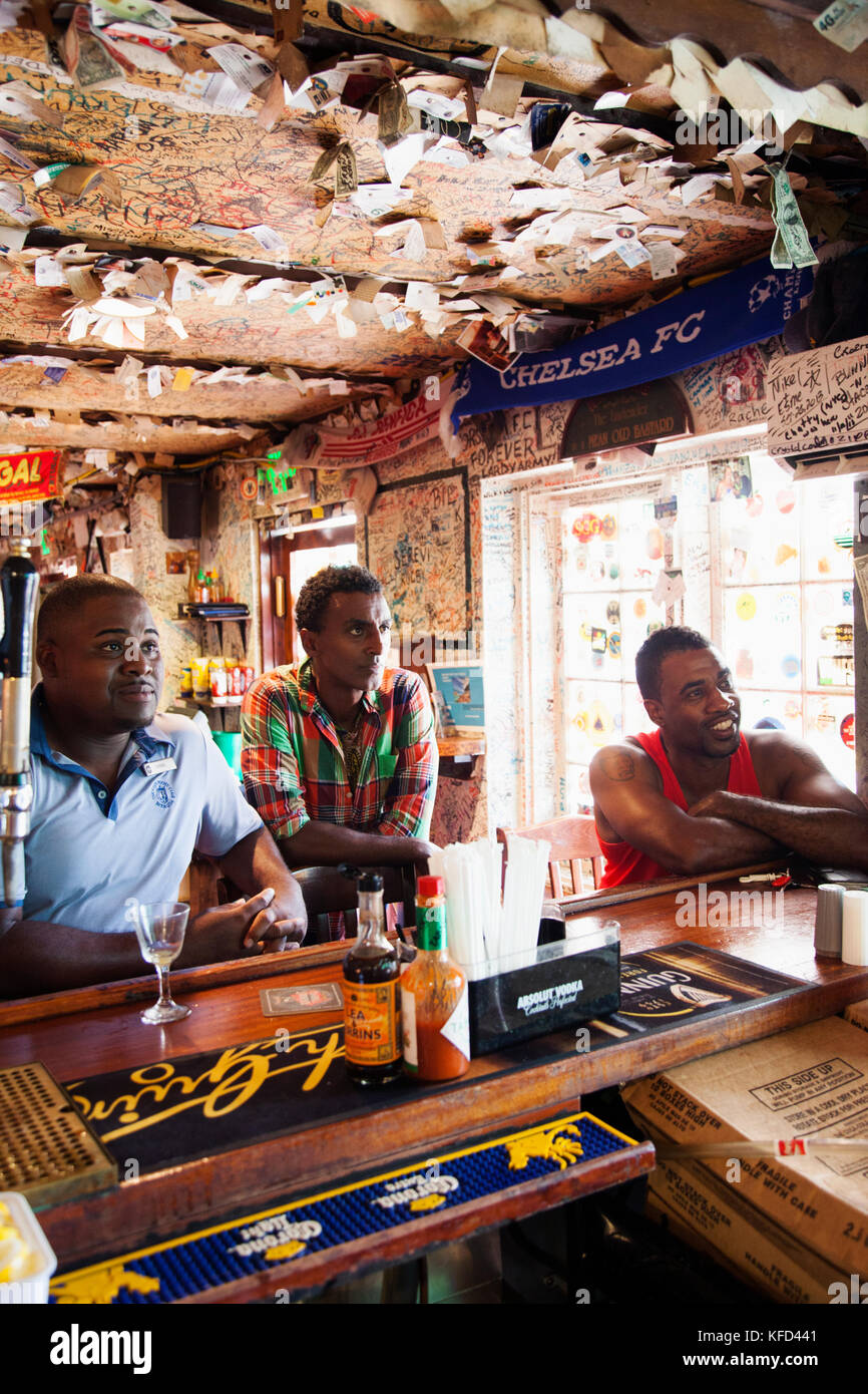 BERUMDA. Chef Marcus Samuelsson having a drink with the locals while watching a soccer game at the Swizzle Inn at Bailey's Bay. Stock Photo
