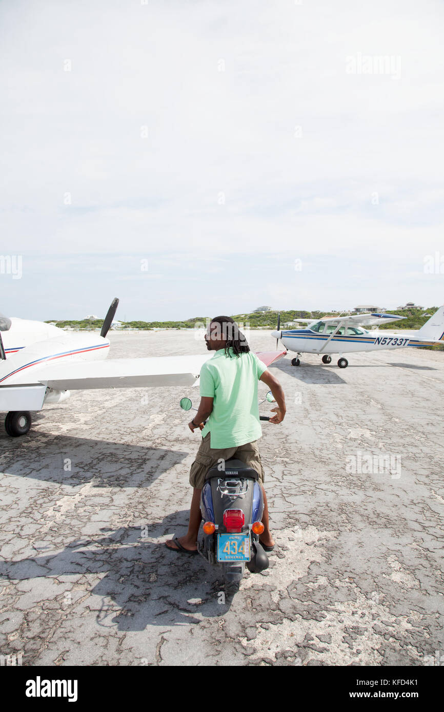 EXUMA, Bahamas. A local man on his scooter at the Staniel Cay Airport