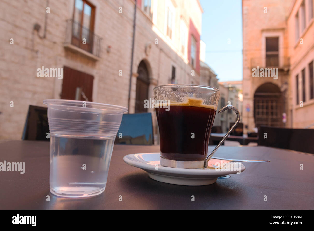 A cup of coffee next to a pair of glasses photo – Free Italy Image