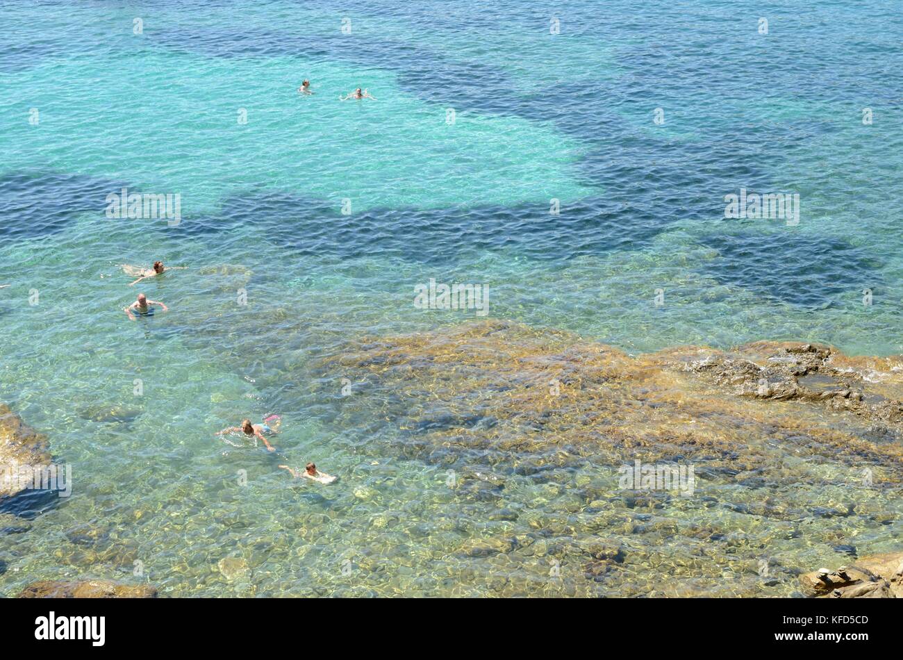 People having a bath in the transparent water of the Mediterranean sea ...