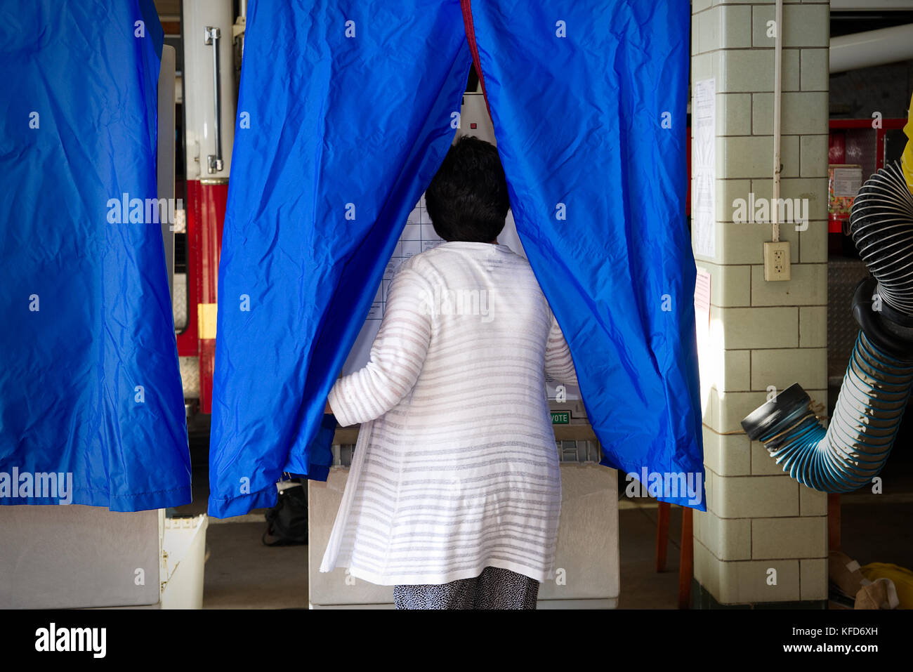 On Election Day, American citizens cast the ballot at a polling station located inside a Philadelphia, PA fire station. Stock Photo