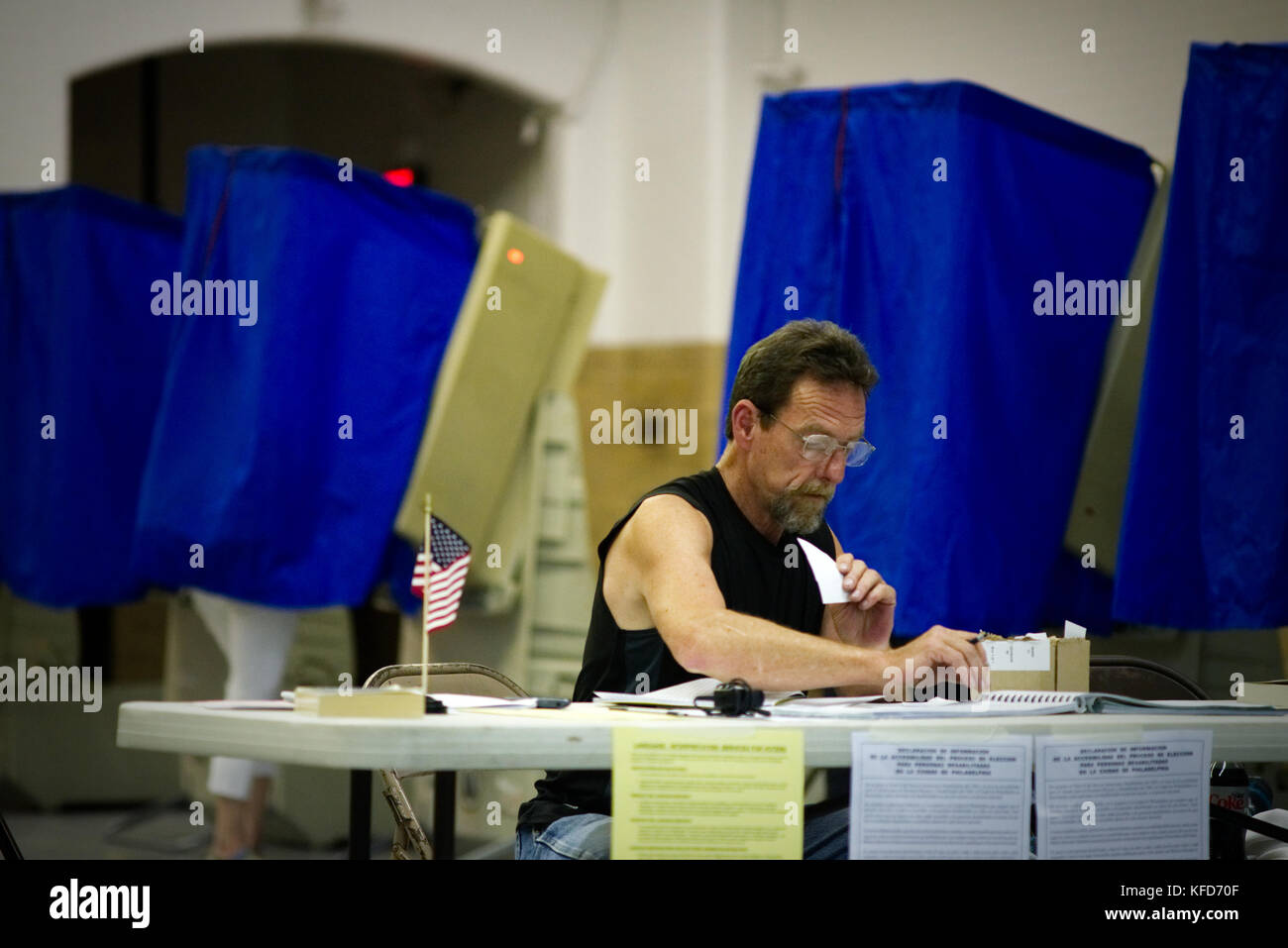On Election Day a poll worker sits behind a table at a Philadelphia, PA polling station. Stock Photo