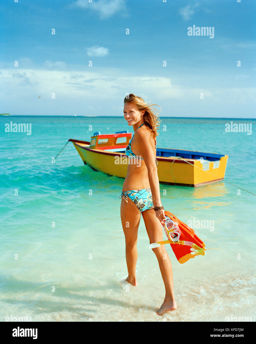 ARUBA, young woman in bikini walking into water with snorkel and mask, Surfside Beach, Oranjestad Stock Photo