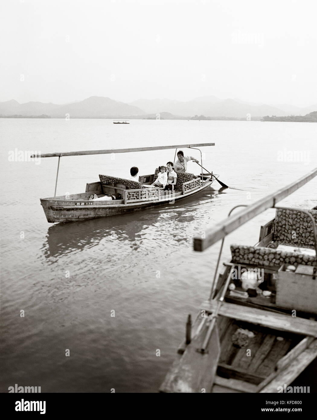 CHINA, Hangzhou, family taking a tour in a boat on West Lake (B&W) Stock Photo