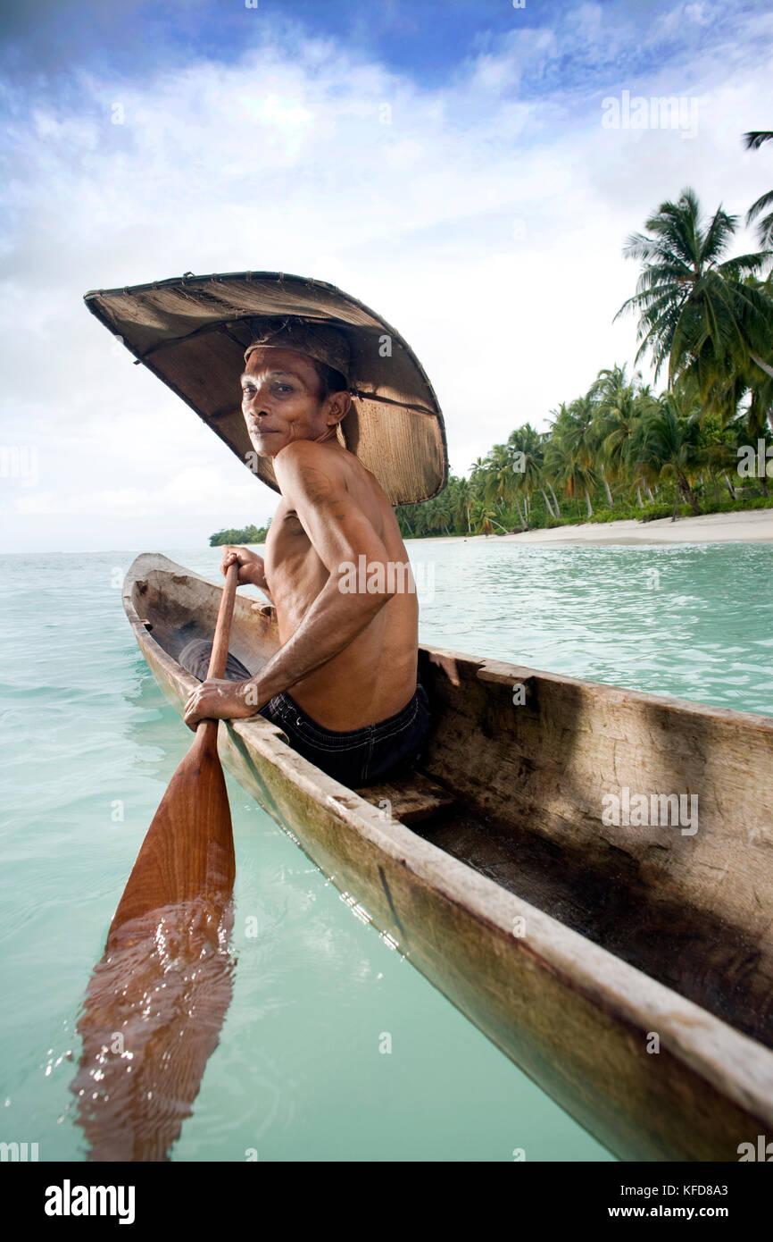 INDONESIA, Mentawai Islands, Kandui Resort, portrait of a Mentawai fisherman, Gesayas Ges, in his dugout canoe Stock Photo